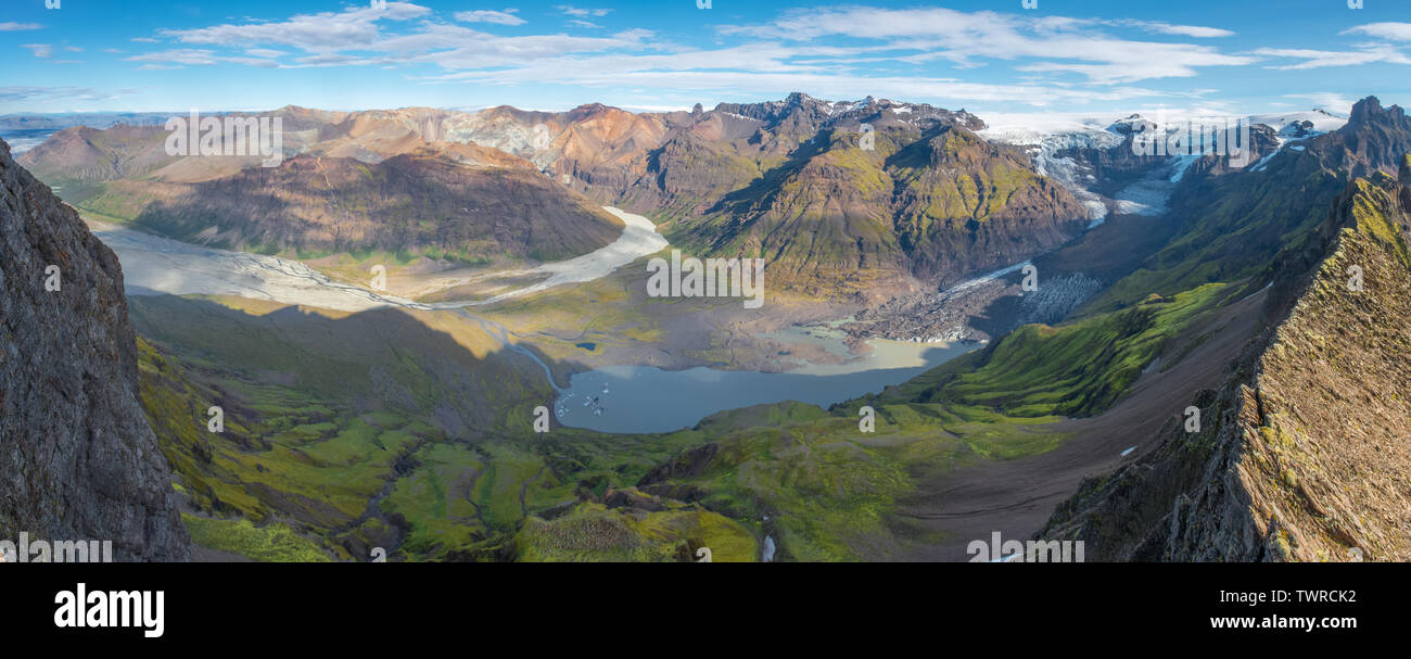 Panoramic view from the top of a mountain ridge of Vatnajokull icefield in Skaftafell National Park, Iceland. Glacier tongue with moraine and lagoon. Stock Photo