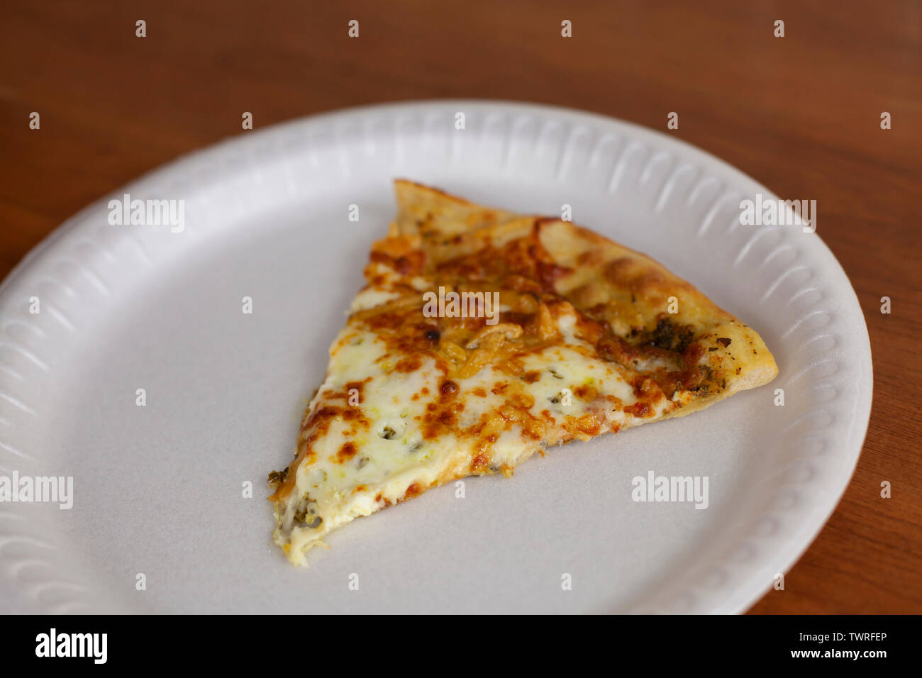 A Single Slice Of Cheese Pizza On A White Plate Stock Photo