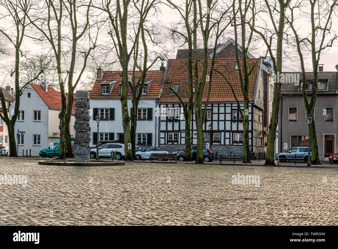 Dusseldorf, Germany - Jan 29, 2019: View at the old houses at the square by St. Margareta Catholic parish church in Dusseldorf, Gerresheim, Germany. Stock Photo