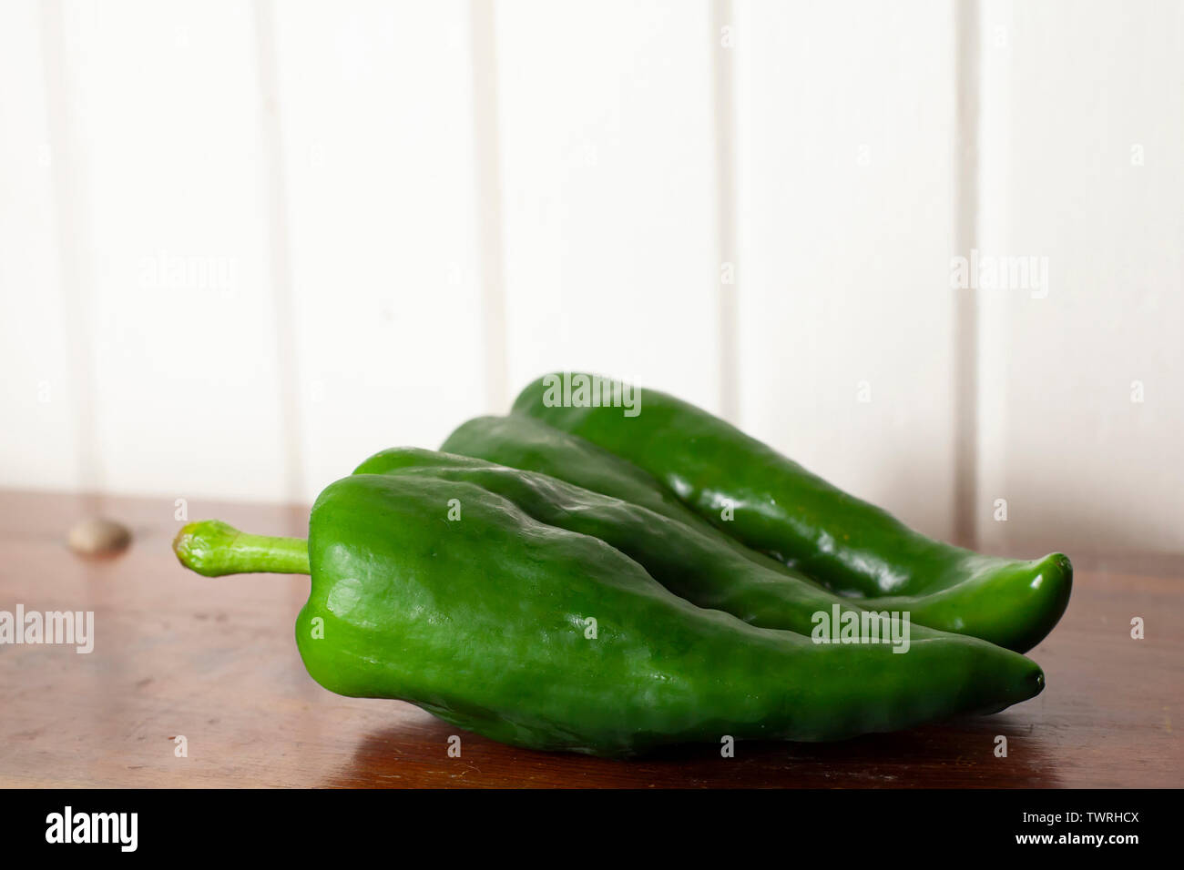 Pair of poblano peppers on a wooden table Stock Photo