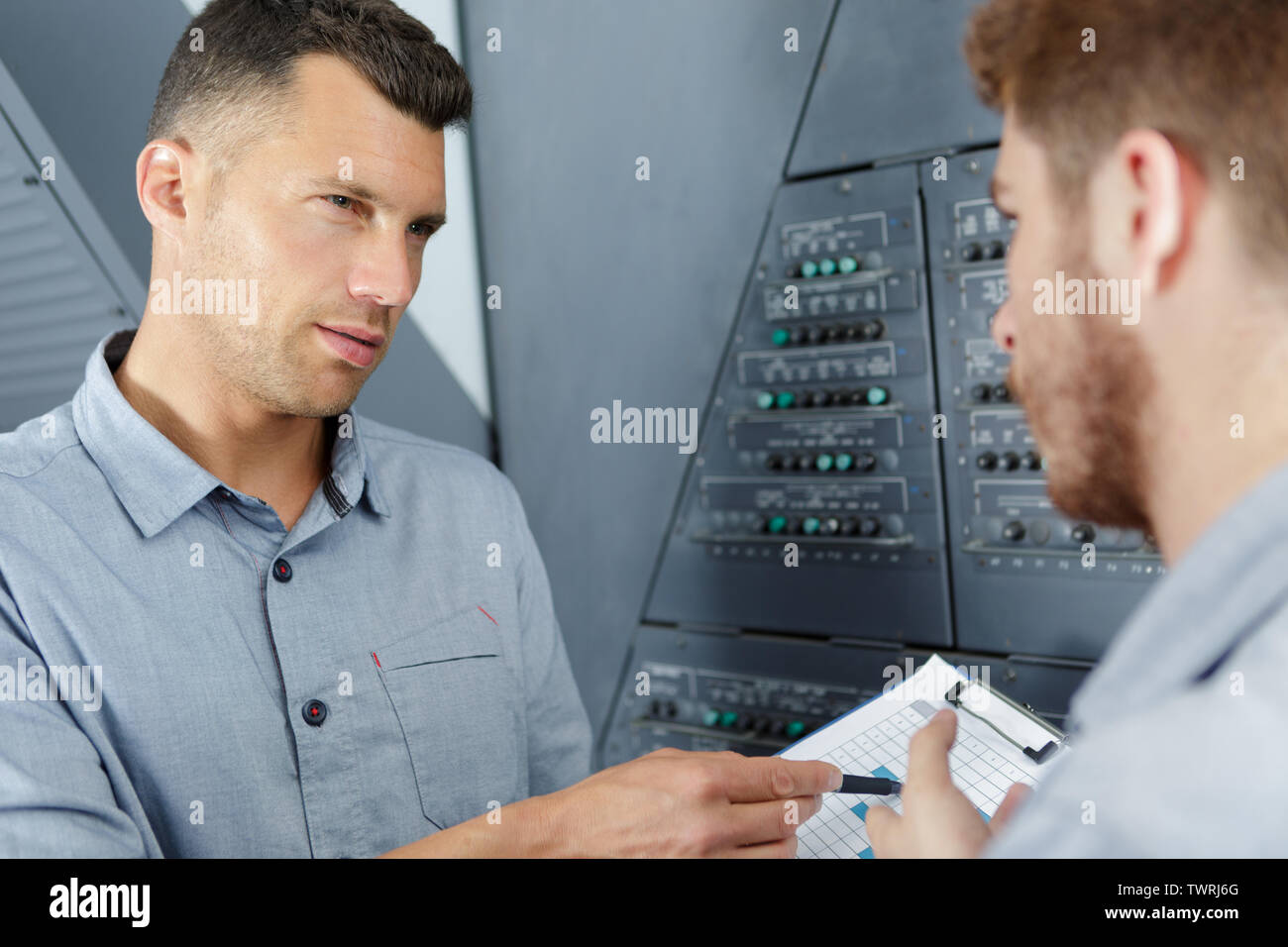 aero engineer and apprentice working in hangar Stock Photo
