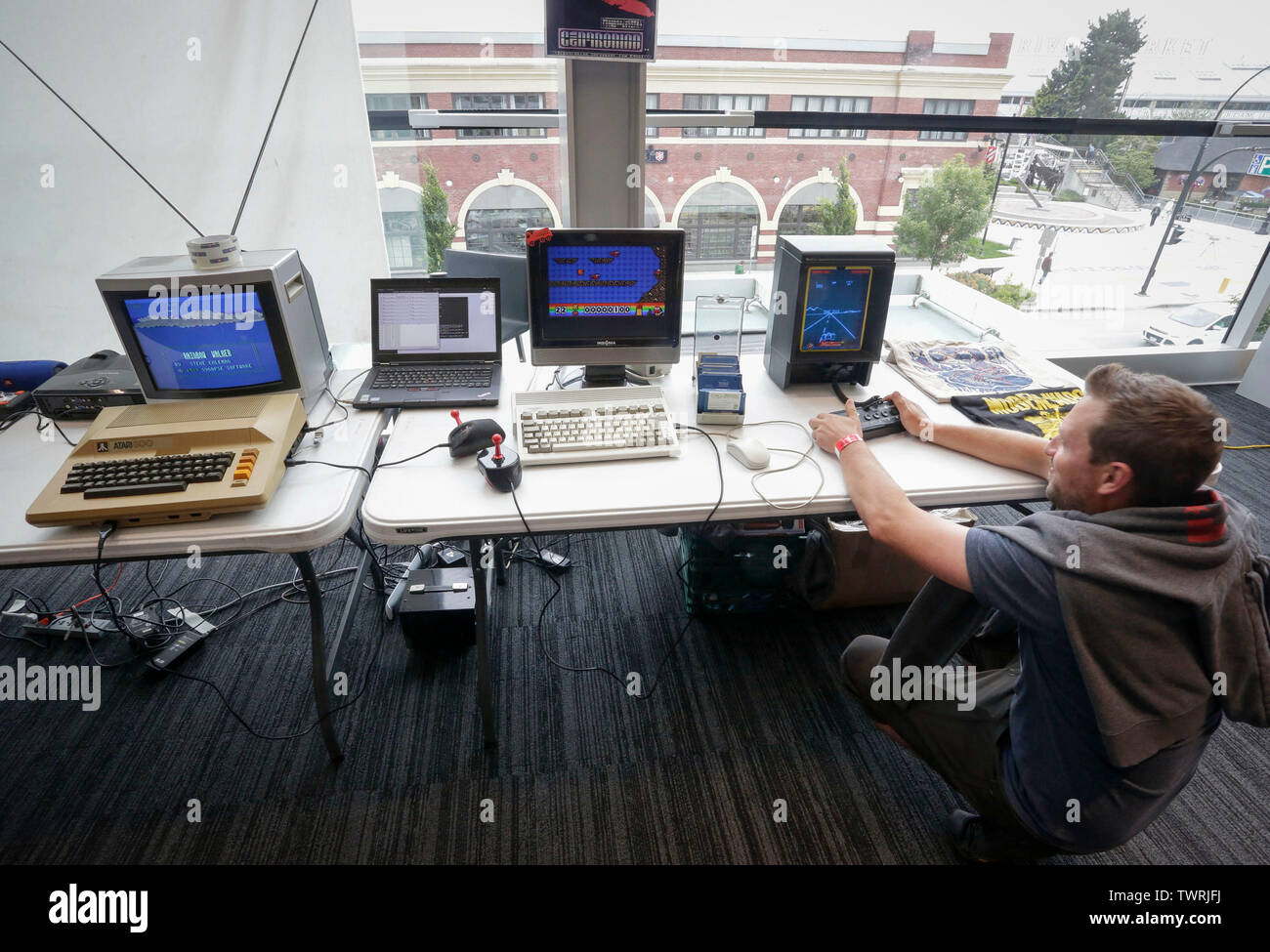 Vancouver, Canada. 22nd June, 2019. A visitor tries a computer game at the Vancouver Retro Gaming Expo in New Westminster, Canada, June 22, 2019. The Vancouver Retro Gaming Expo was held at the Anvil Centre on Saturday, offering different collections of video games, consoles and collectibles from 1970s to 1990s. Credit: Liang Sen/Xinhua/Alamy Live News Stock Photo