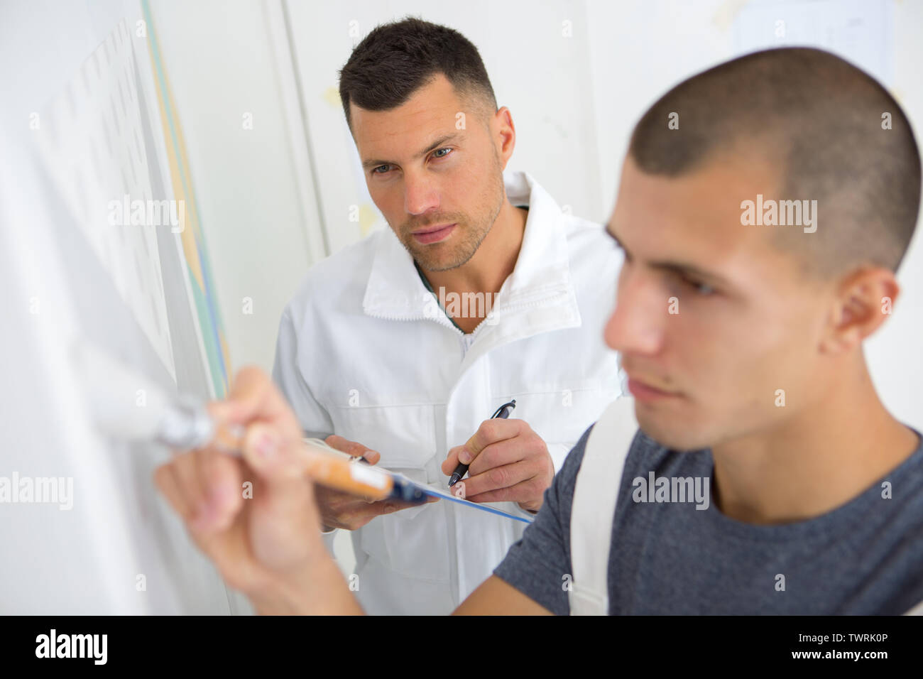supervisor assessing trainee painter Stock Photo