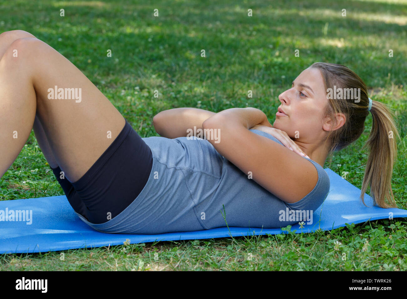 woman doing crunches exercise on yoga mat Stock Photo Alamy