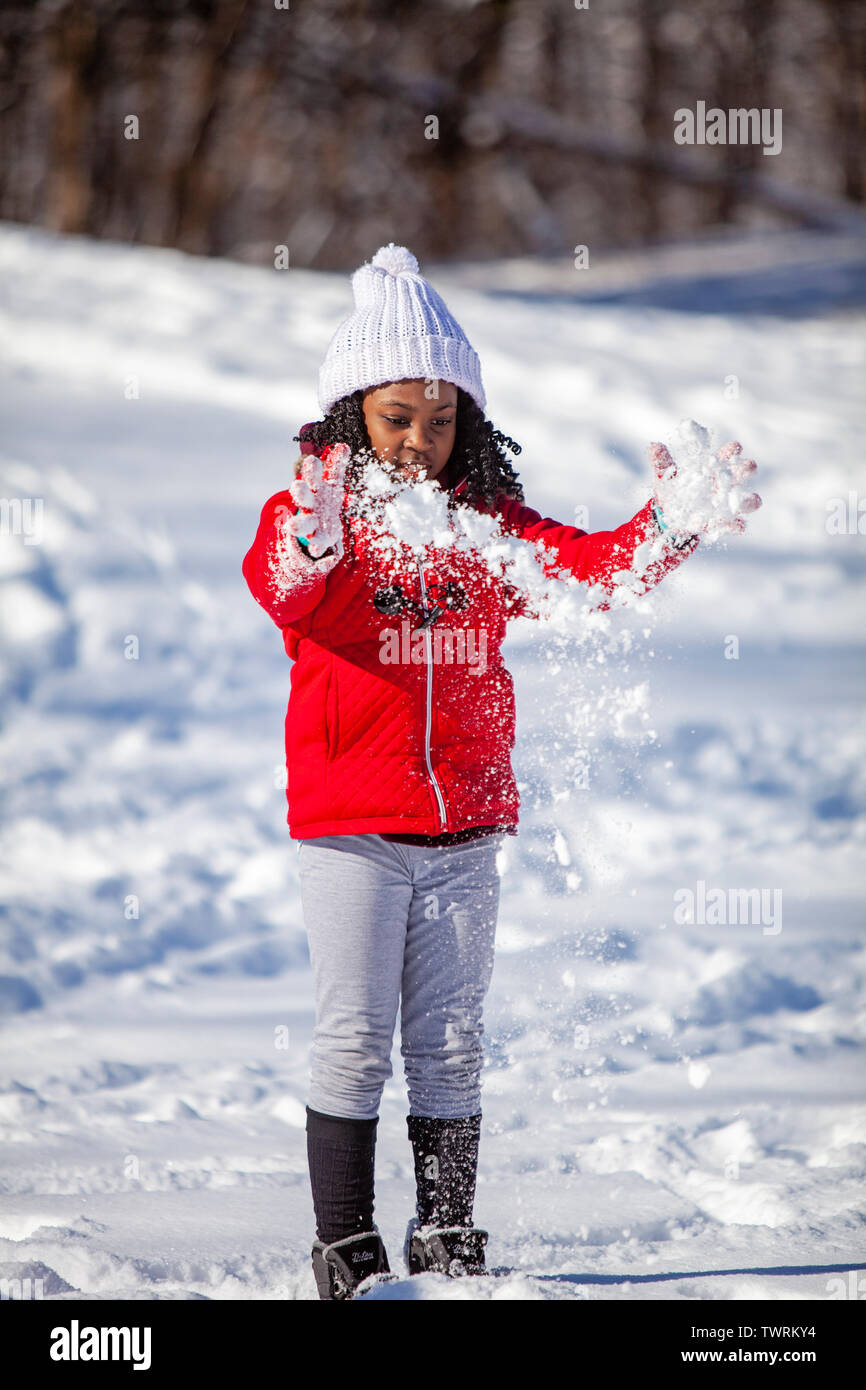 A black girl playing with snow in winter attire Stock Photo - Alamy