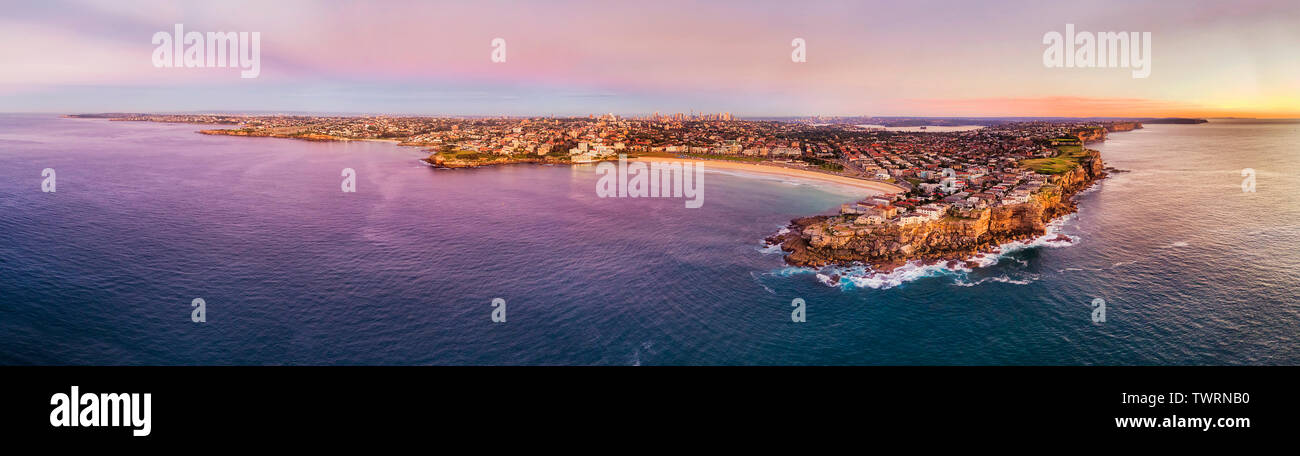 Pink sunrise from Pacific ocean over Sydney city coast around Bondi beach between sandstone cliff headlands of eastern suburbs - iconic beach of Austr Stock Photo