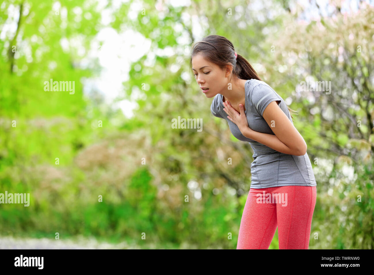 Nausea nauseous and sick ill runner vomiting. Running woman feeling bad about to throw up