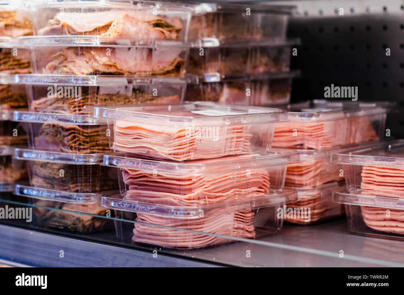 Ham packed and stacked on supermarket shelves for sale retail Stock
