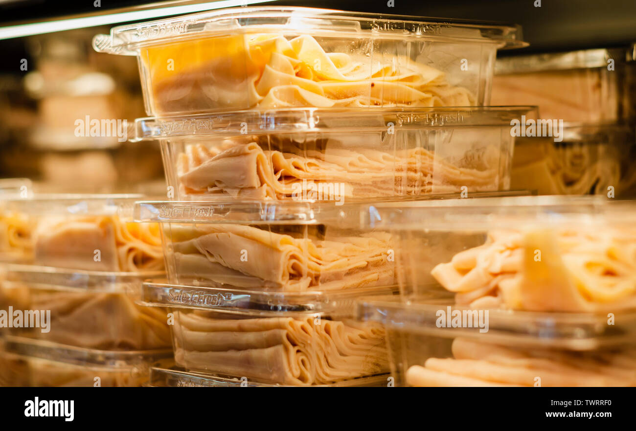 Ham packed and stacked on supermarket shelves for sale retail Stock