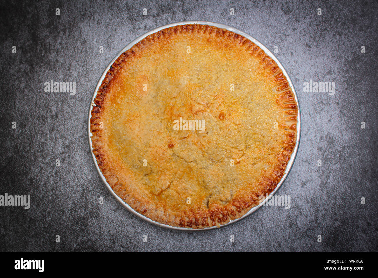 Homemade rustic apple pie on rock black background. Stock Photo