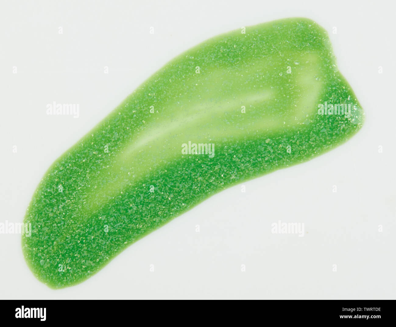 Sparkle light green paint stroke isolated on white background close up view Stock Photo