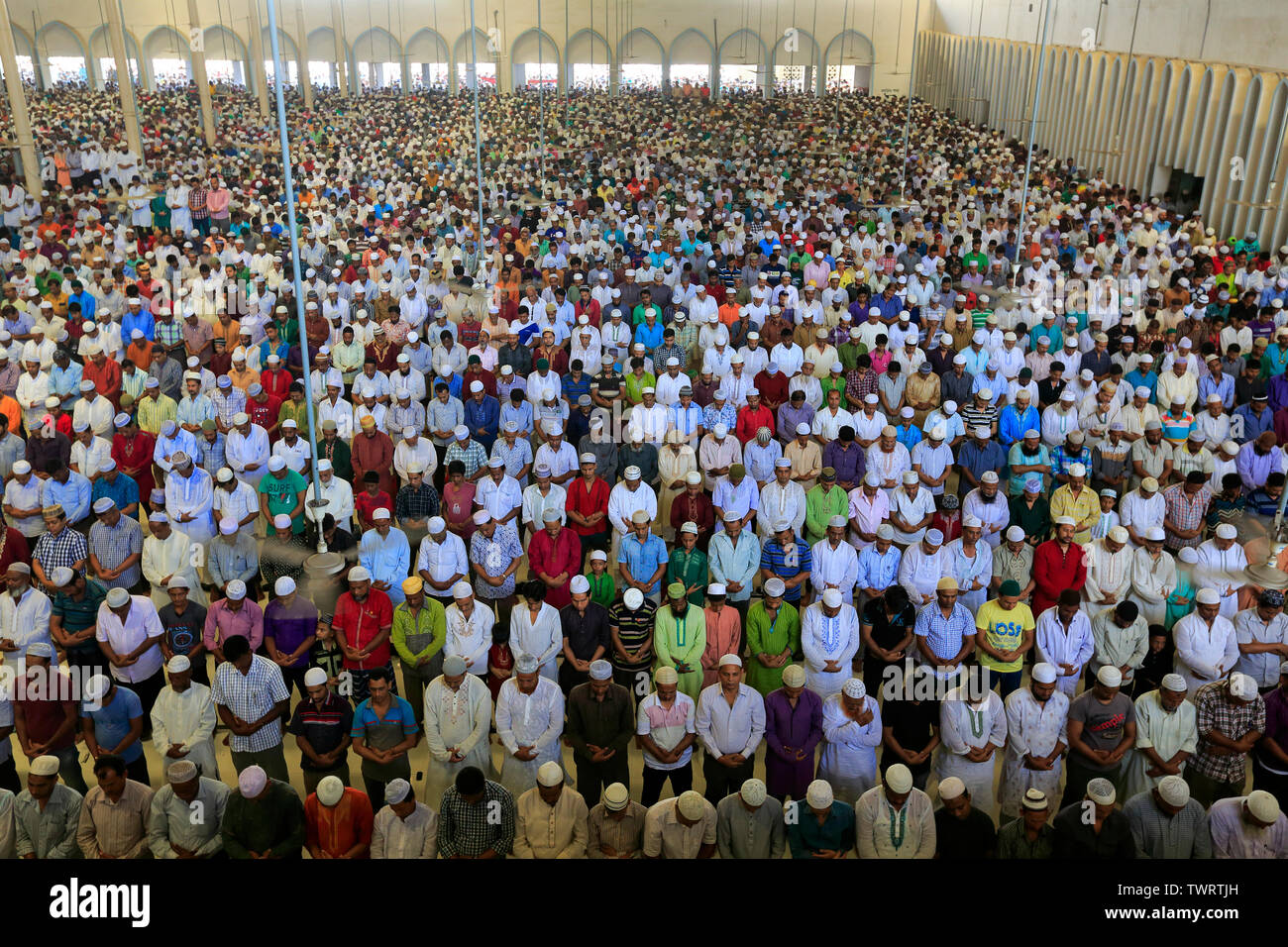 Bangladeshi Muslims offer Eid–ul-Fitr prayers at the Baitul Mukarram National Mosque in Dhaka, Bangladesh. Stock Photo