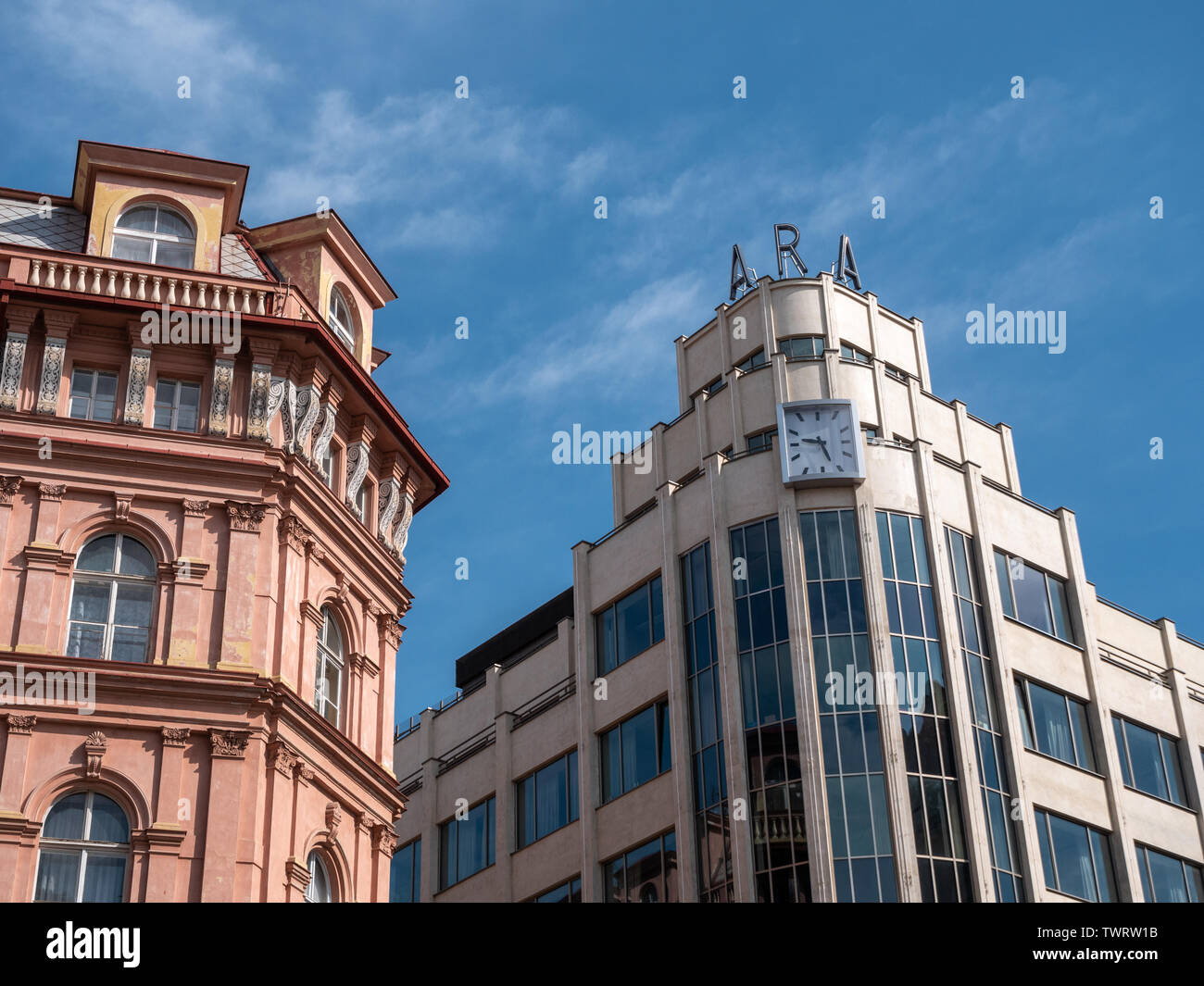 Prague, Czech Republic - June 10 2019: Classic and Modern, Old and New Architecture Meeting in Prague, Czech Republic. Modernist ARA building and its classicist neighbor. A Concept for Changes or Difference in Archtectural Style. Stock Photo