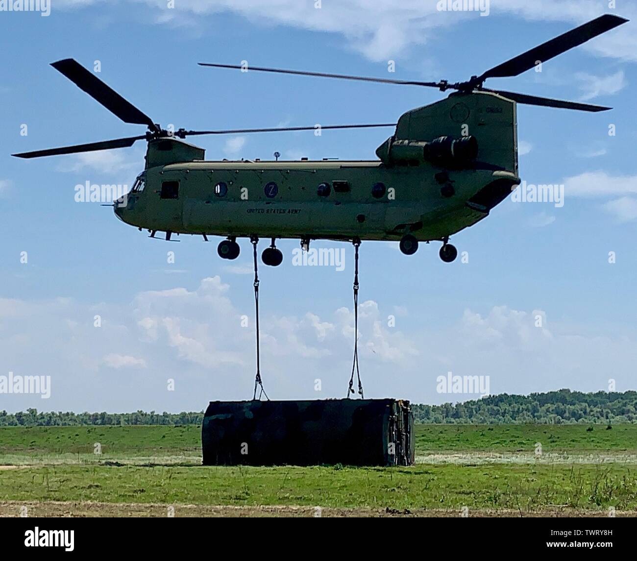 A U.S. Army CH-47 Chinook from the 12th Combat Aviation Brigade begins to lift a raft section in Bordusani, Romania June 20, 2019 during Saber Guardian 19. Saber Guardian 19 is an exercise co-led by the Romanian Joint Force Command and U.S. Army Europe, taking place from June 3 - 24 at various locations in Bulgaria, Hungary and Romania. Saber Guardian 19 is designed to improve the integration of multinational combat forces. (U.S. Army photo by Cpt. Erica Mitchell) Stock Photo