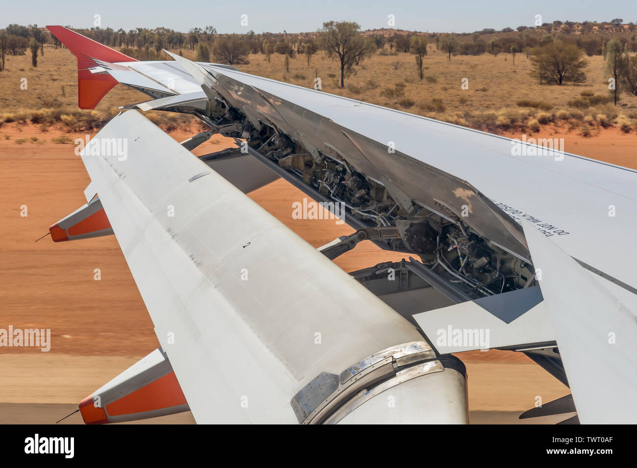 Airplane activates ground spoilers as it lands at Ayers Rock airport, Australia Stock Photo