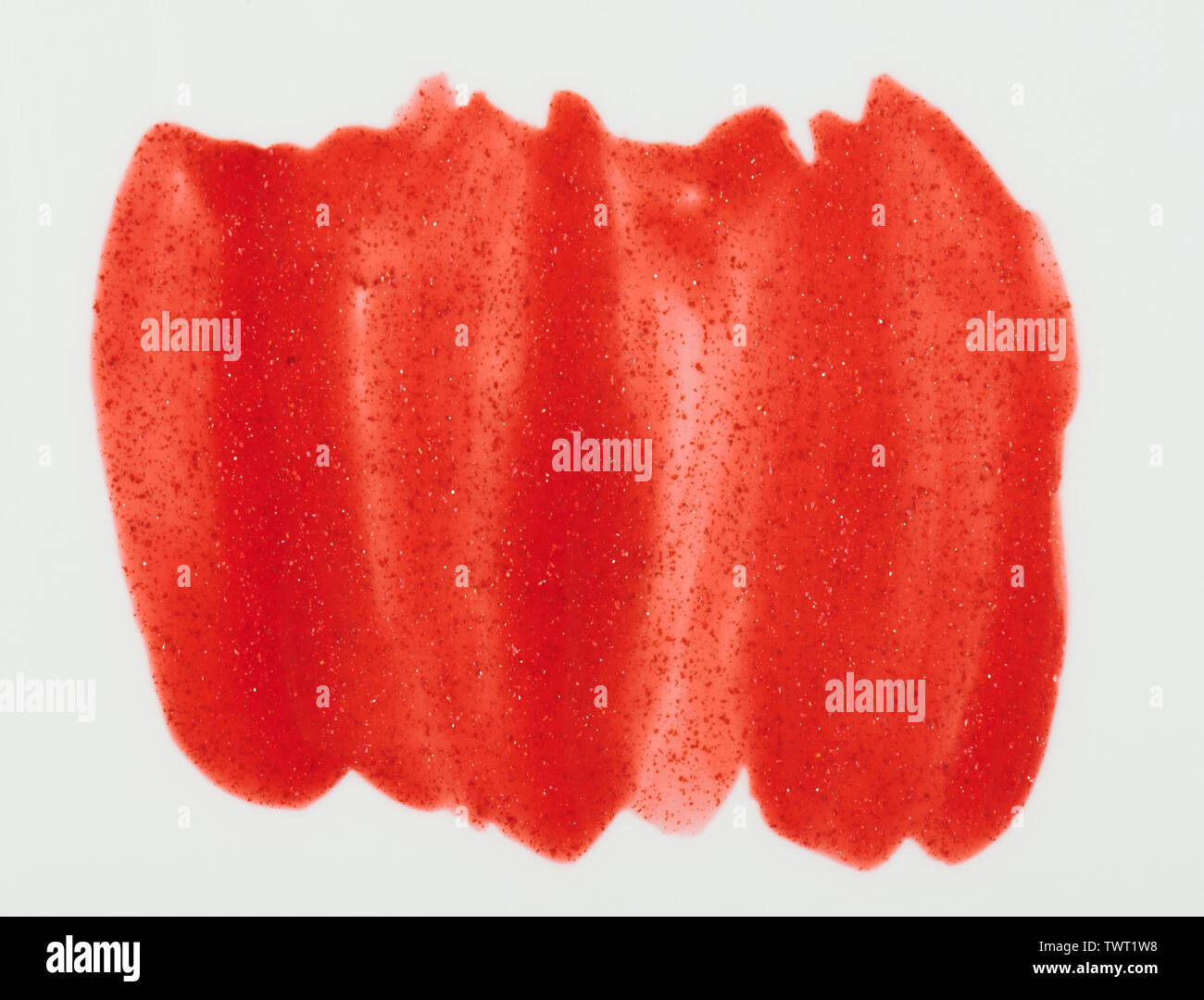 Sparkle red paint stain isolated on white background close up view Stock Photo