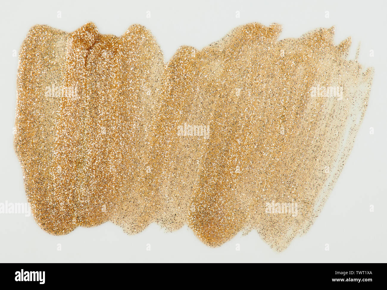 Sparkle gold color paint stain isolated on white background close up view Stock Photo