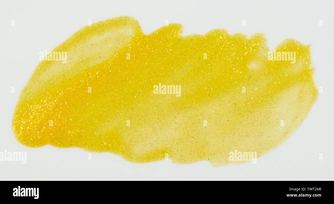 Sparkle yellow paint stain isolated on white background close up view Stock Photo