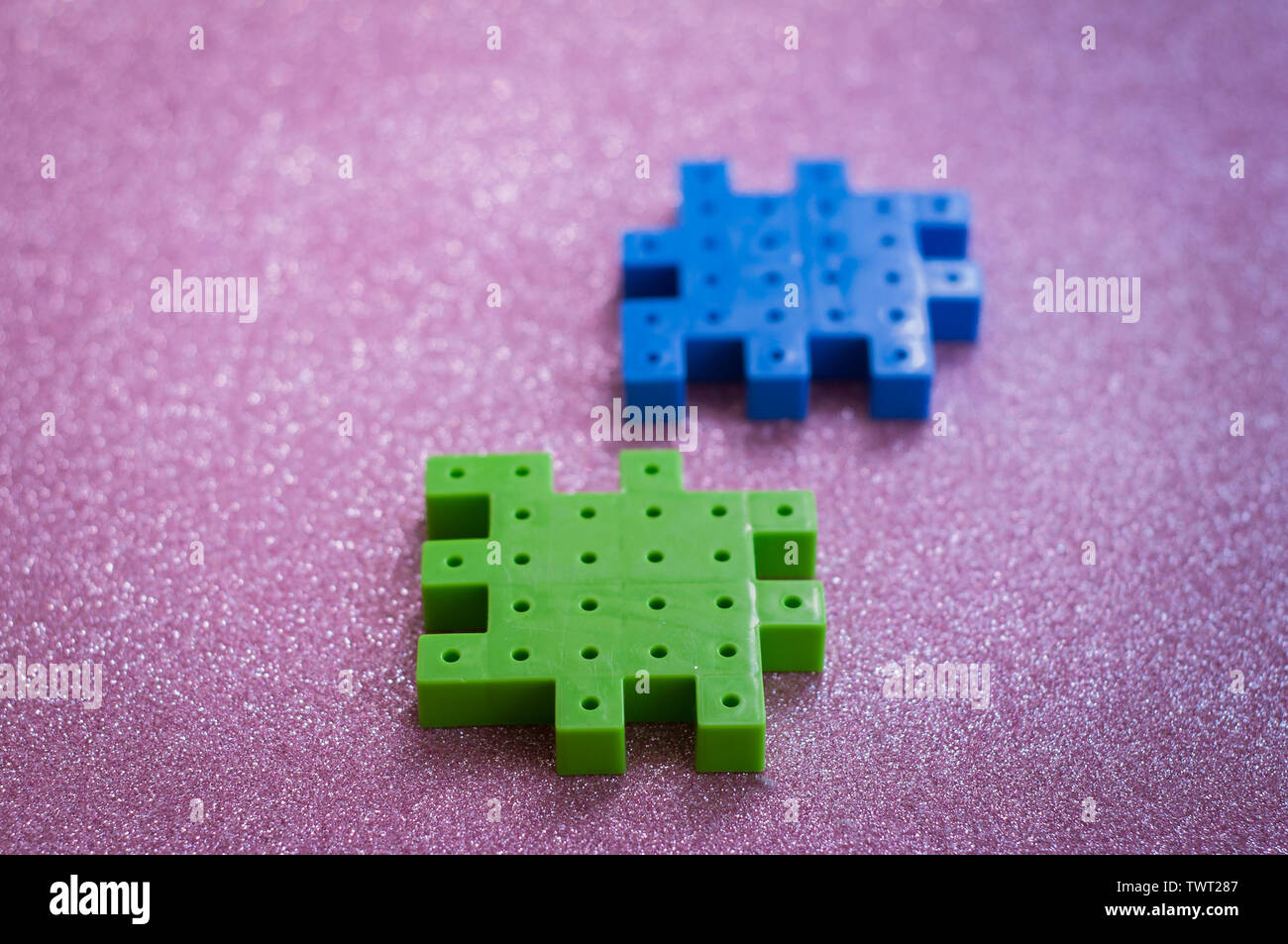 Colorful plastic puzzle pieces on pink Background Stock Photo Alamy