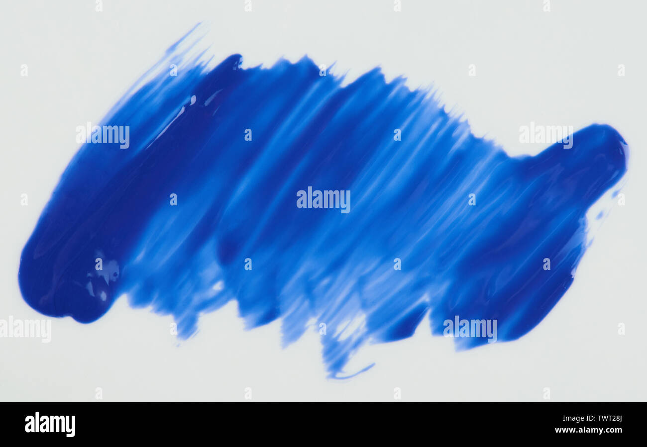 Glossy blue  paint stain isolated on white background close up view Stock Photo