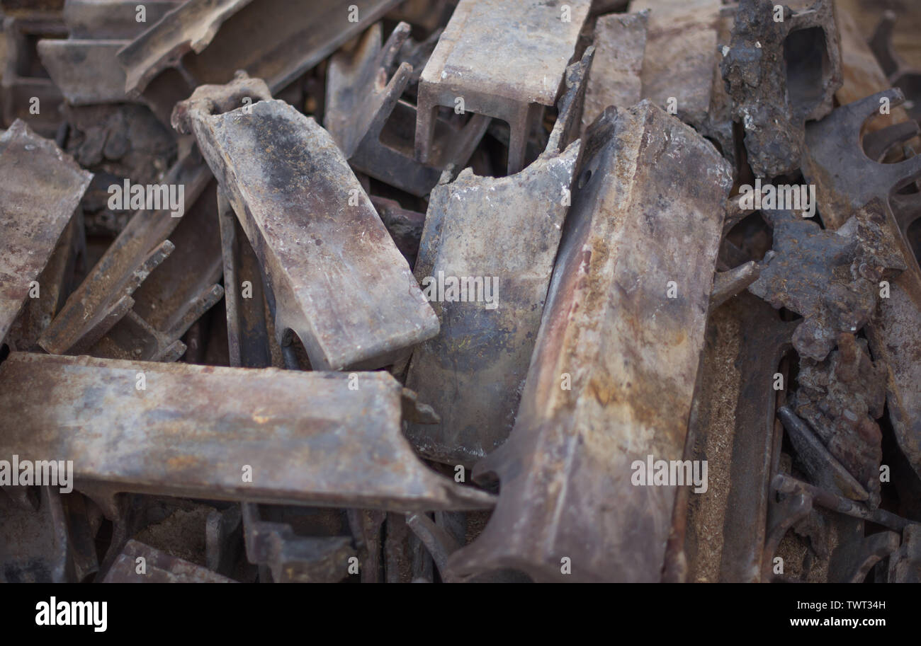 Pile of burnt-out cast iron parts of the industrial firebox. Selective focus. Stock Photo