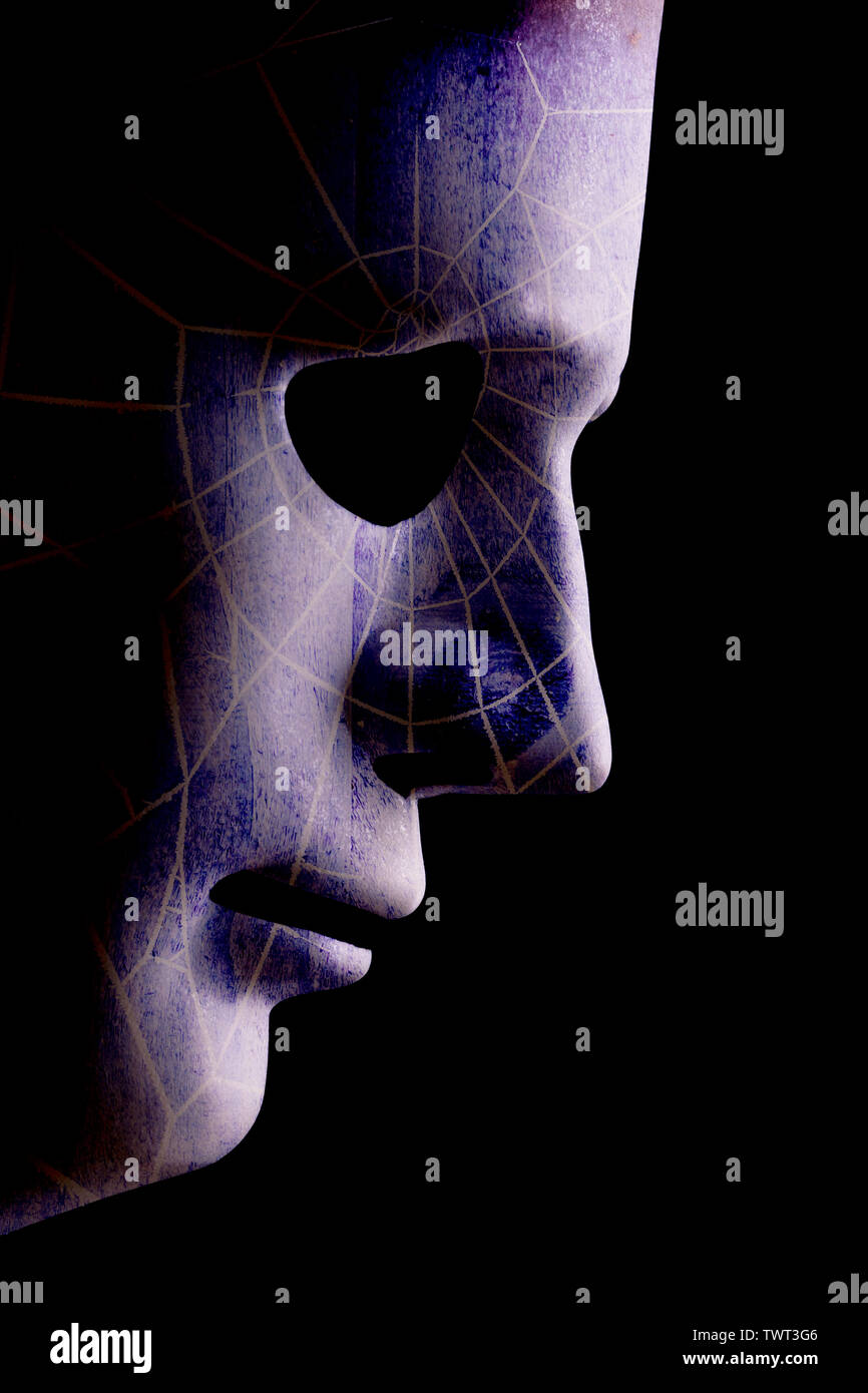 Robot face mask side view close up with textured skin and blank eyes. Black background and space for text. Artificial intelligence concept in a human Stock Photo