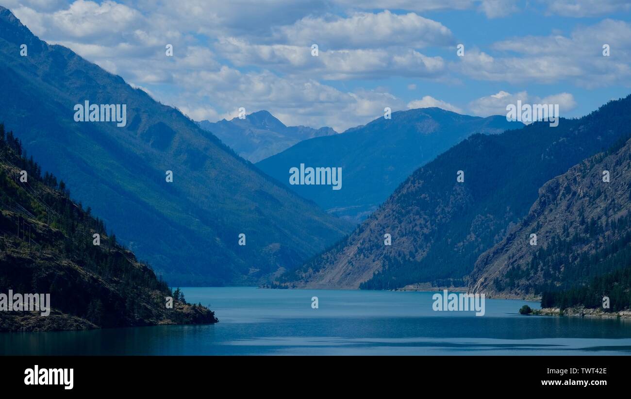 huge mountain range right next to a clear water lake Stock Photo - Alamy