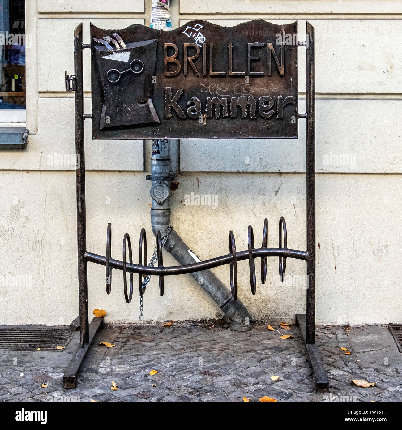 Decorative bicycle stand for parking bikes outside Brillen Kammer optician in Friedrichshain, Berlin Stock Photo