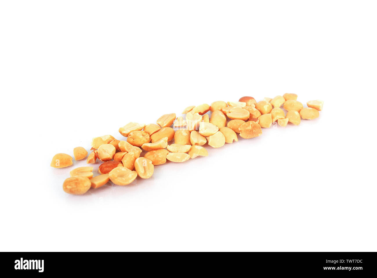 Ground roasted peanuts on white background Stock Photo - Alamy