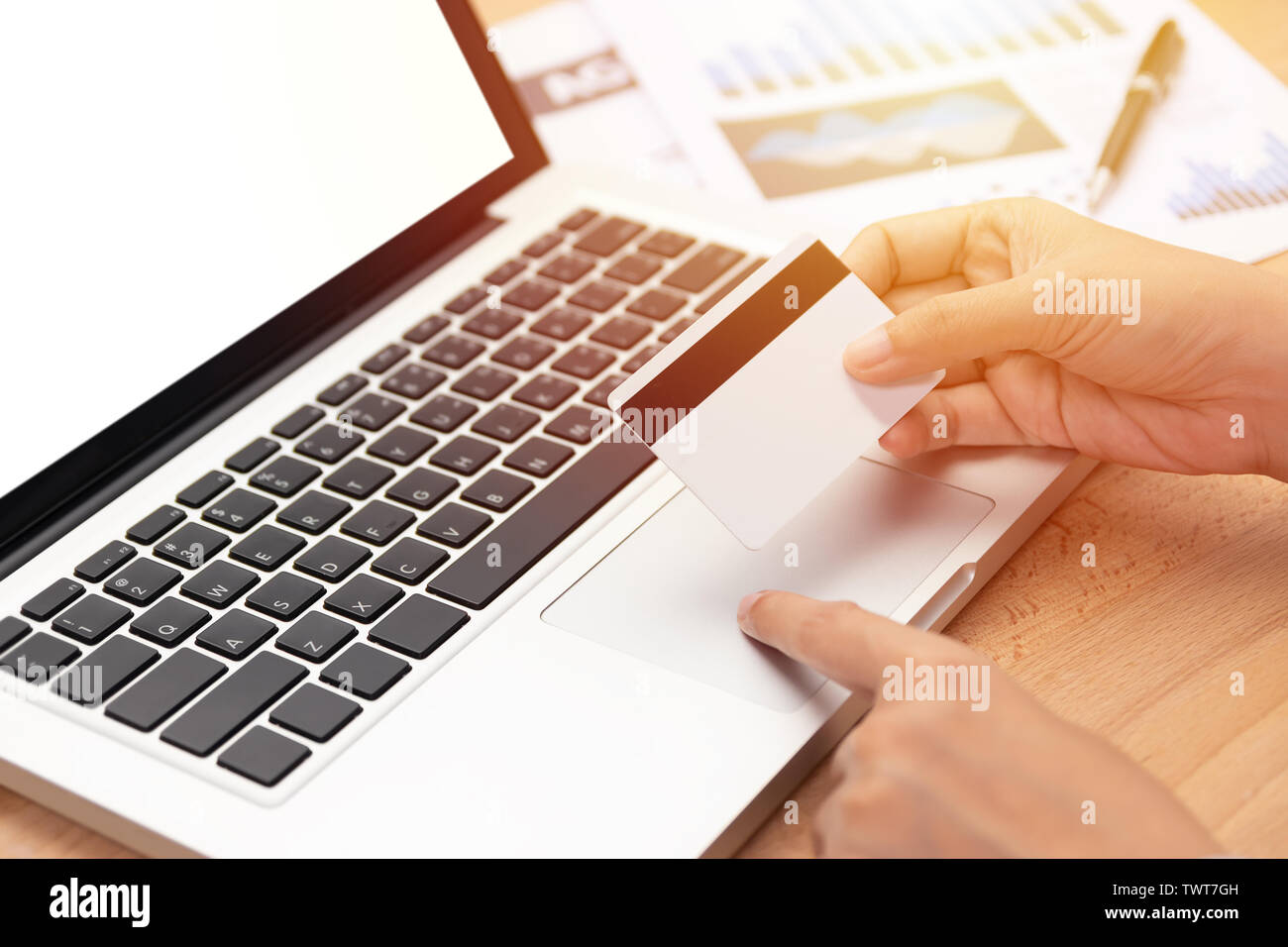 e-commerce and shopping online concept. woman holding a credit card and purchase making online payment via computer notebook with blank white screen i Stock Photo
