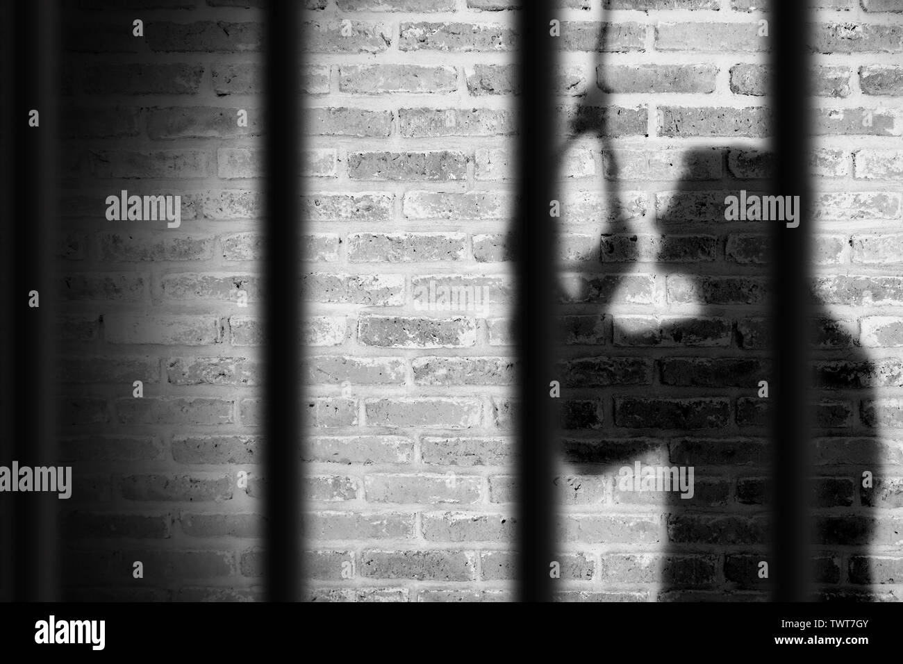 shadow of prisoner man hanging suicide inside the jail. light and shadow Stock Photo