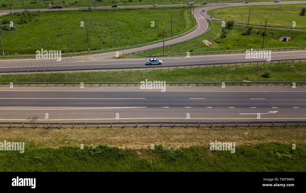 Aerial view of modern highway road intersection on rural landscape ...