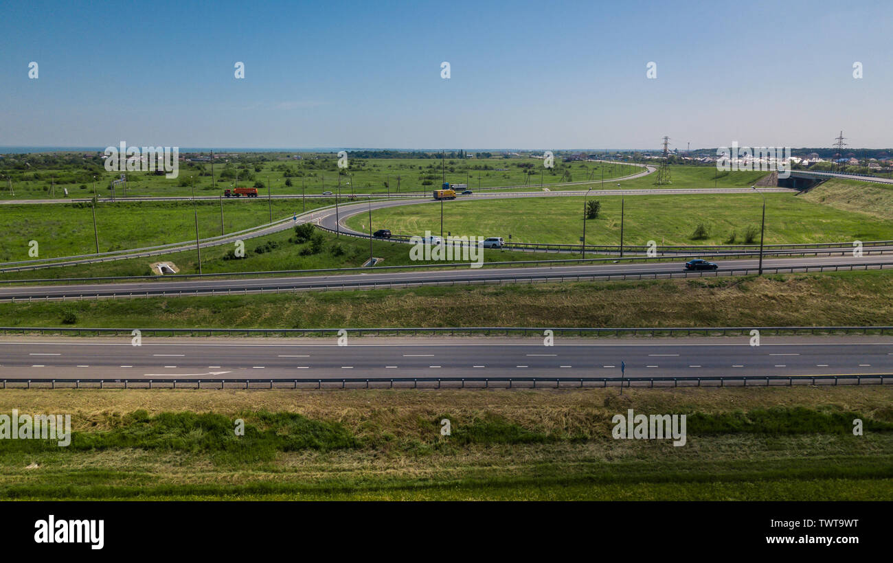Aerial view of modern highway road intersection on rural landscape ...