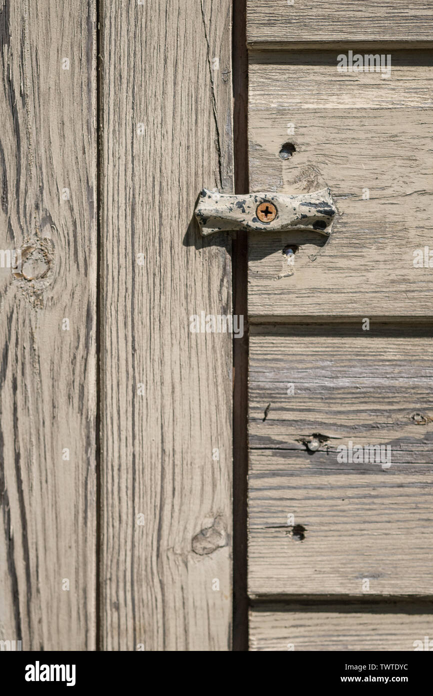 Very basic latch on bleached wooden garden shed. Stock Photo