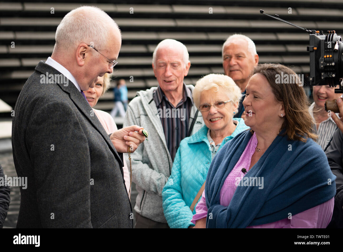 Dundee, Scotland, UK. 23 June 2019. The BBC Antiques Roadshow TV programme is aiming on location t the new V&A Museum in Dundee today. Long queues formed as members of the public arrived with their collectables to have them appraised and valued by the Antiques Roadshow experts. Select items and their owners were chosen to be filmed for the show. Pictured, Expert Geoffrey Munn discussing valuable jewellery with an owner. Credit: Iain Masterton/Alamy Live News Stock Photo