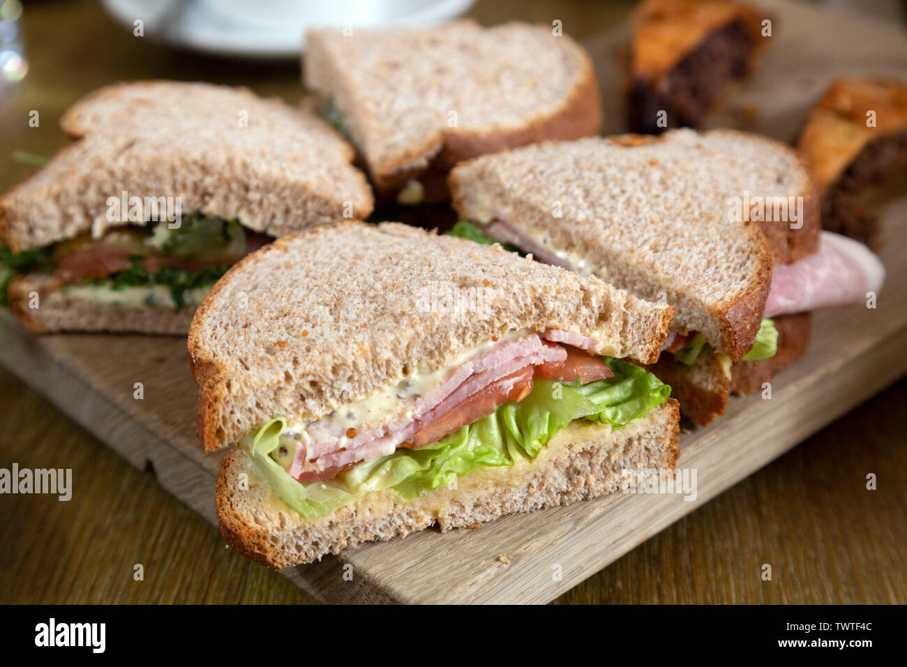 Ham sandwiches served during an afternoon tea. They are in brown