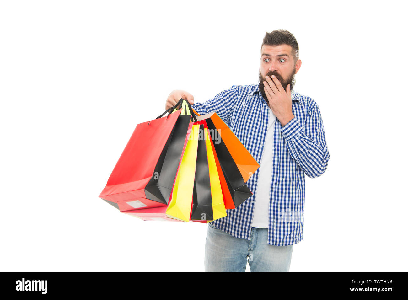 I survived Black Friday. Surprised hipster holding shopping bags after Black Friday isolated on white. Bearded man opening his shopping season on Black Friday. Offering deep discounts on Black Friday. Stock Photo
