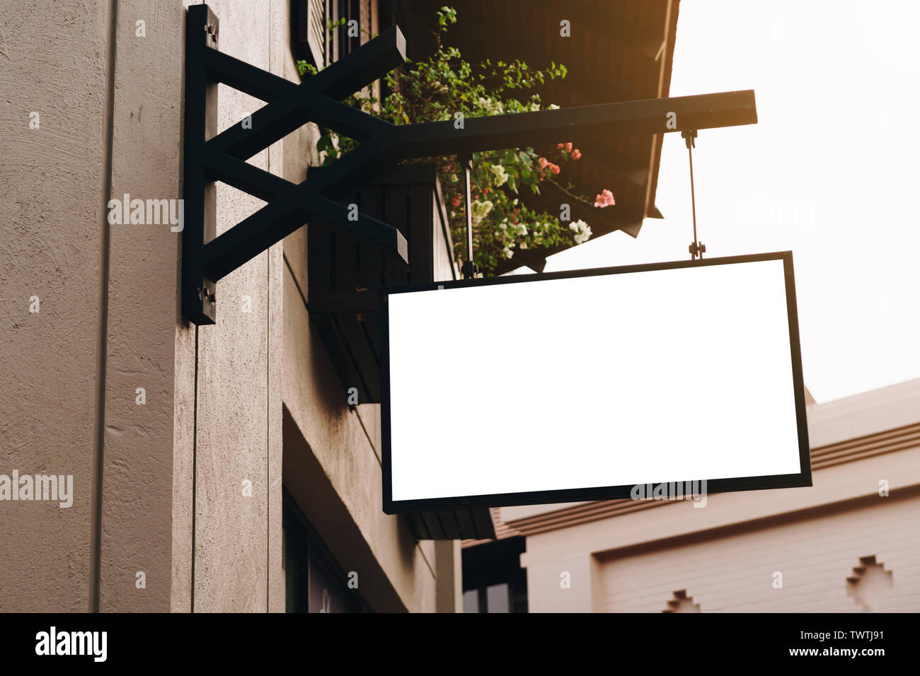 Empty signage and blank mock up hanging on street with copy space Stock ...