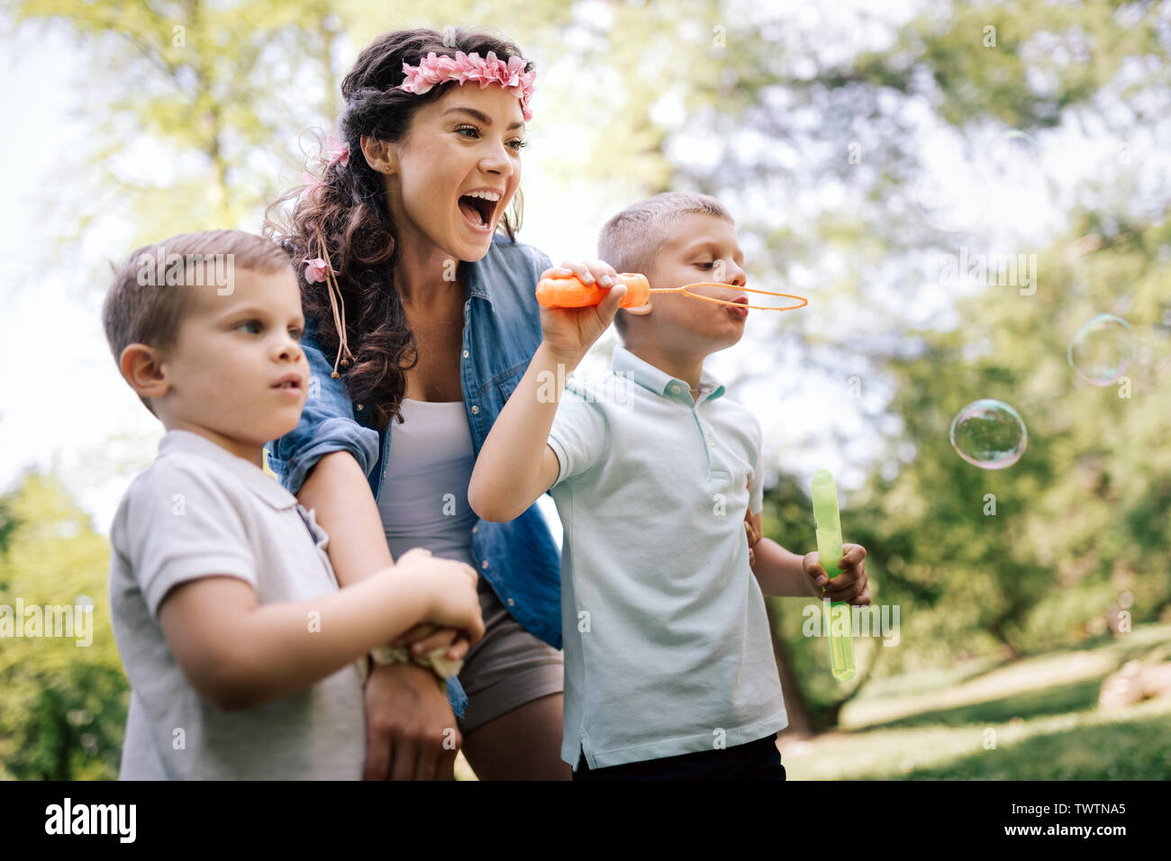 Family with children blow soap bubbles outdoors Stock Photo - Alamy