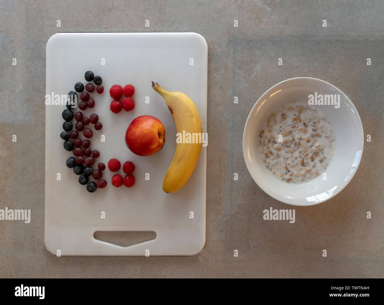 Healthy energy packed breakfast of oat granola and fresh fruit Stock