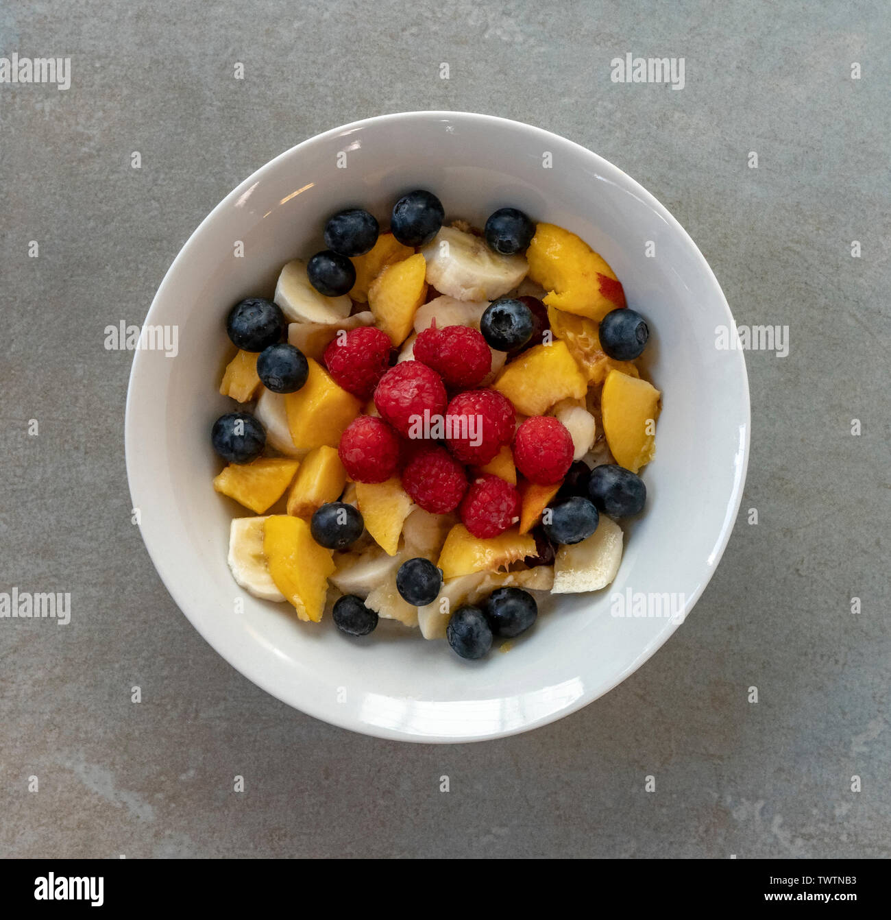 Healthy energy packed breakfast of oat granola and fresh fruit Stock
