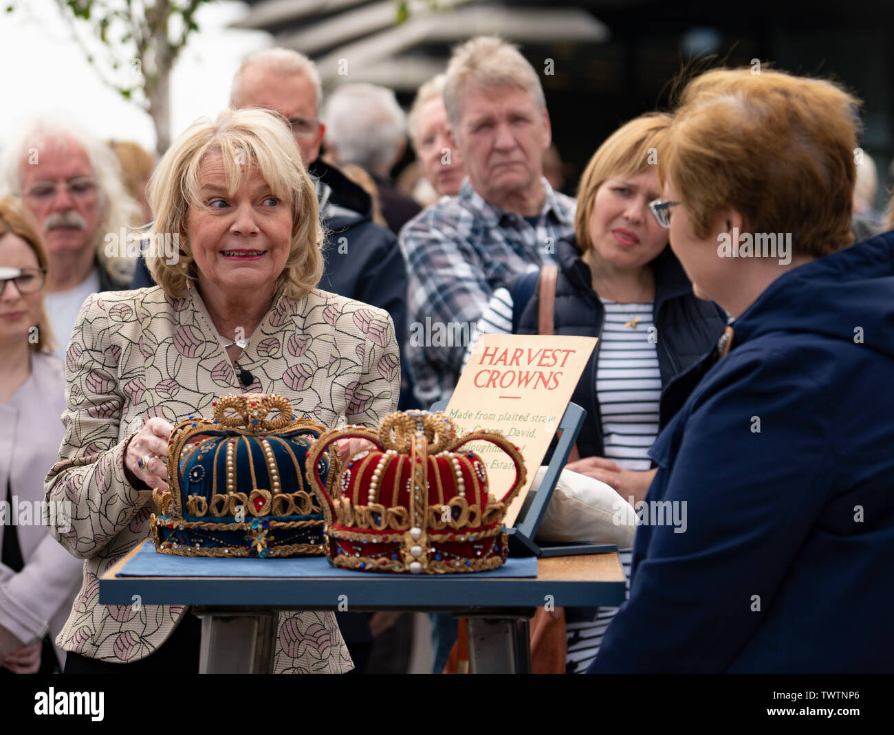 Dundee, Scotland, UK. 23 June 2019. The BBC Antiques Roadshow TV programme is aiming on location t the new V&A Museum in Dundee today. Long queues formed as members of the public arrived with their collectables to have them appraised and valued by the Antiques Roadshow experts. Select items and their owners were chosen to be filmed for the show. Pictured, Judith Miller discusses merits of antiques brought by member of the public Credit: Iain Masterton/Alamy Live News Stock Photo
