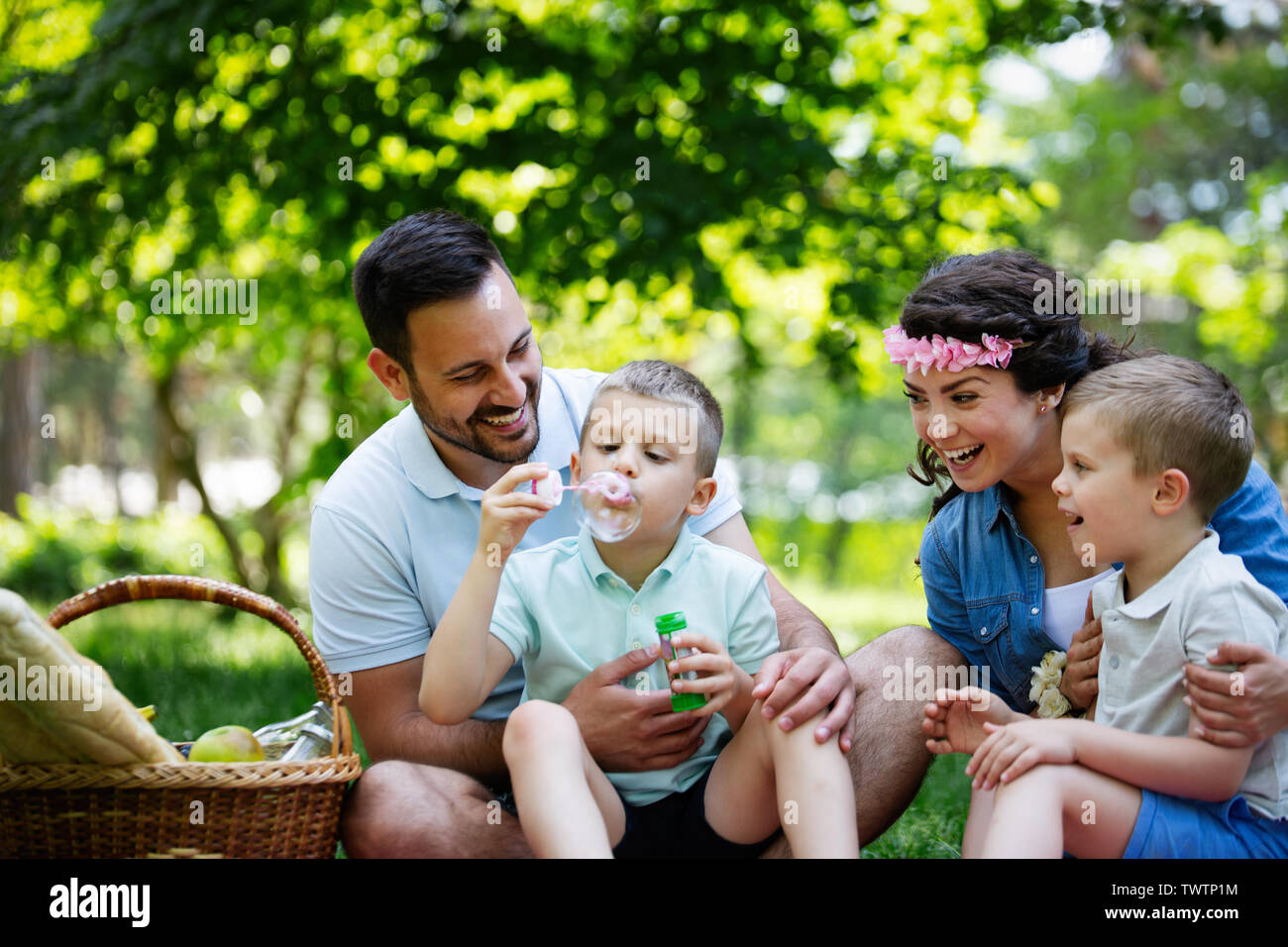 Family with children blow soap bubbles outdoors Stock Photo - Alamy