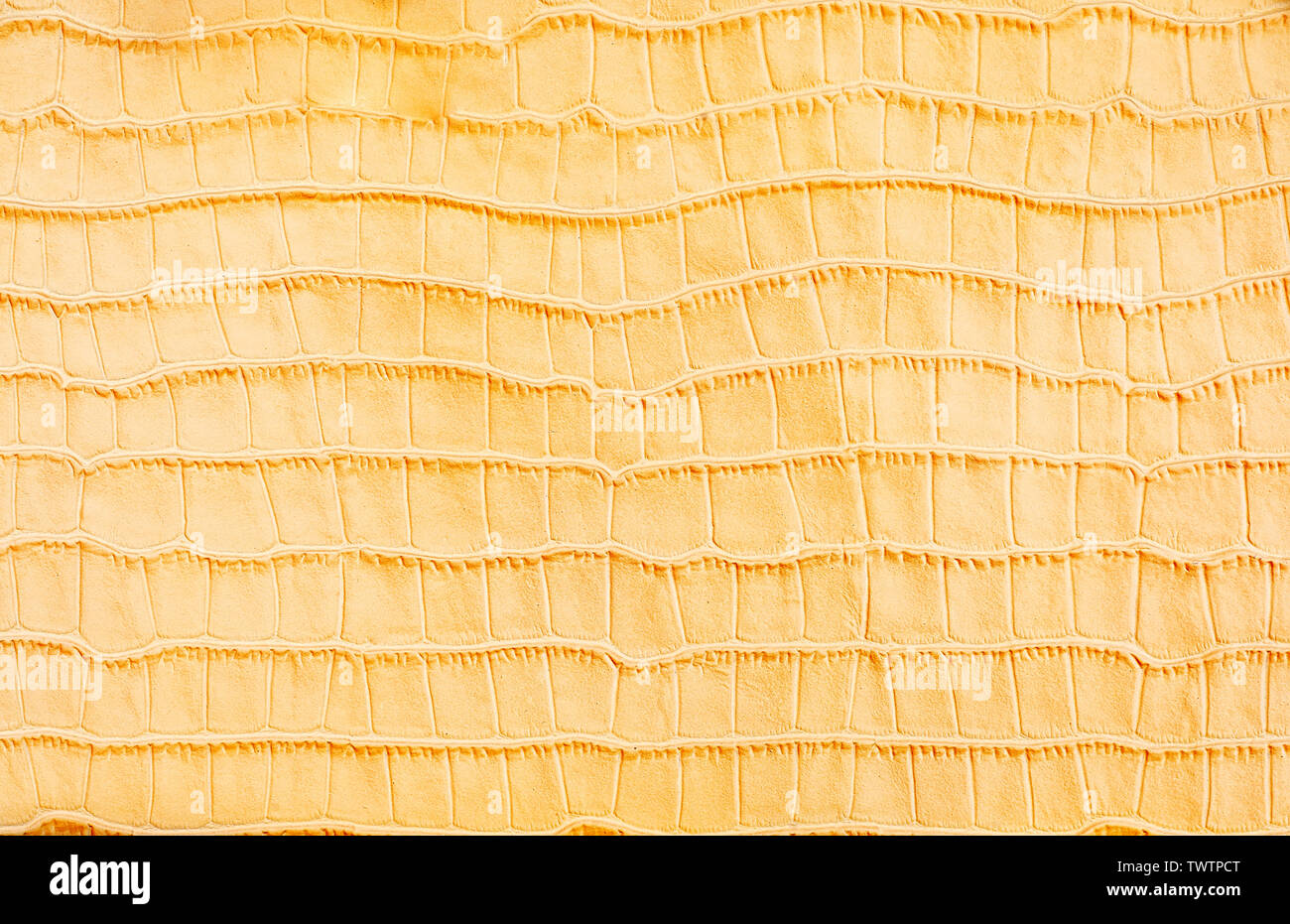Yellow stylized imitation crocodile skin background Stock Photo