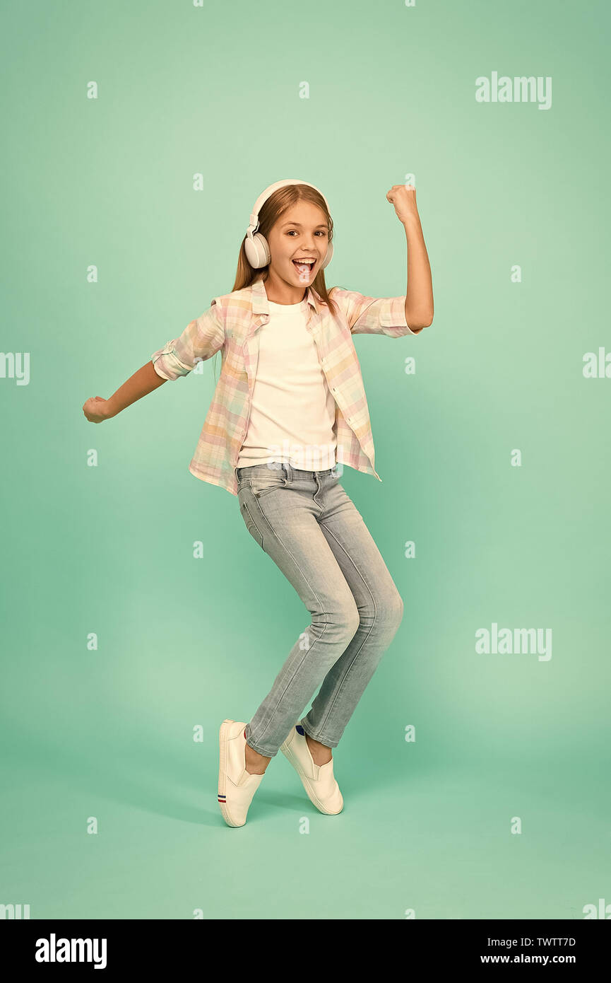 Music is happiness for her. Dancing girl. Happy small girl dancing to