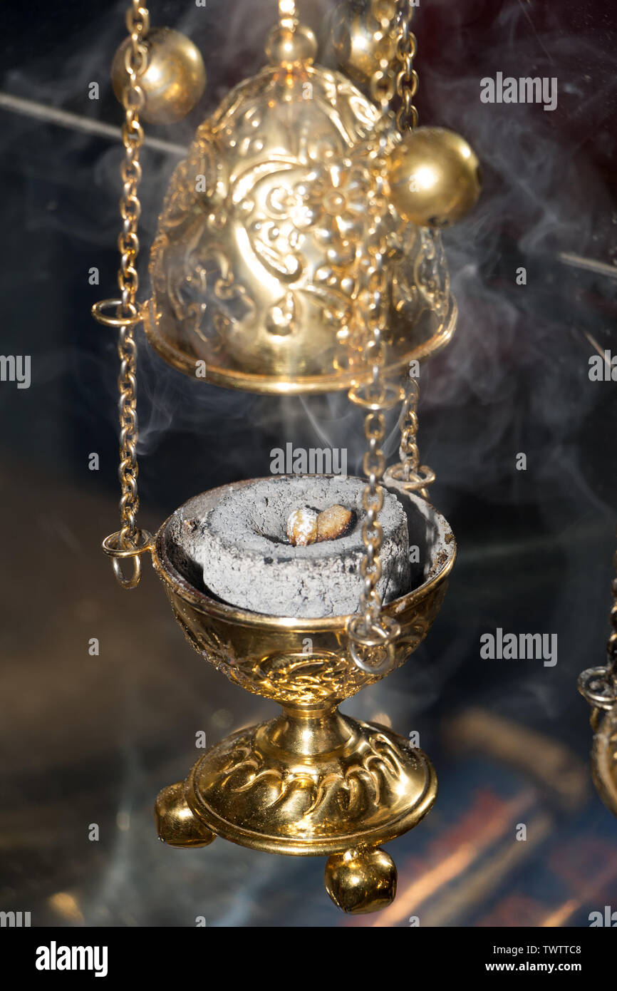 Thurible triple chain incense burner in clouds of smoke. Golden censer with  burning charcoal inside. Close-up. Service in eastern orthodox church conc  Stock Photo - Alamy