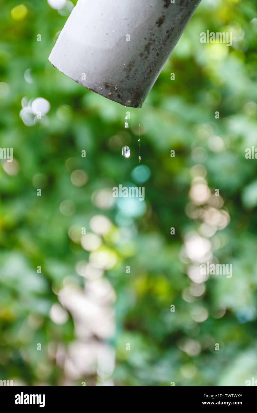 Water is dripping from an old pipe on a house outside Stock Photo Alamy