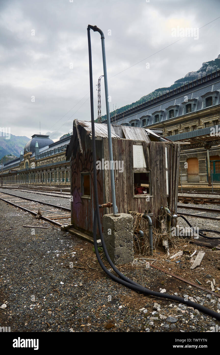 Neglected water pumping facility next to the railways at Canfranc International railway station front (Canfranc, Pyrenees, Huesca, Aragon, Spain) Stock Photo