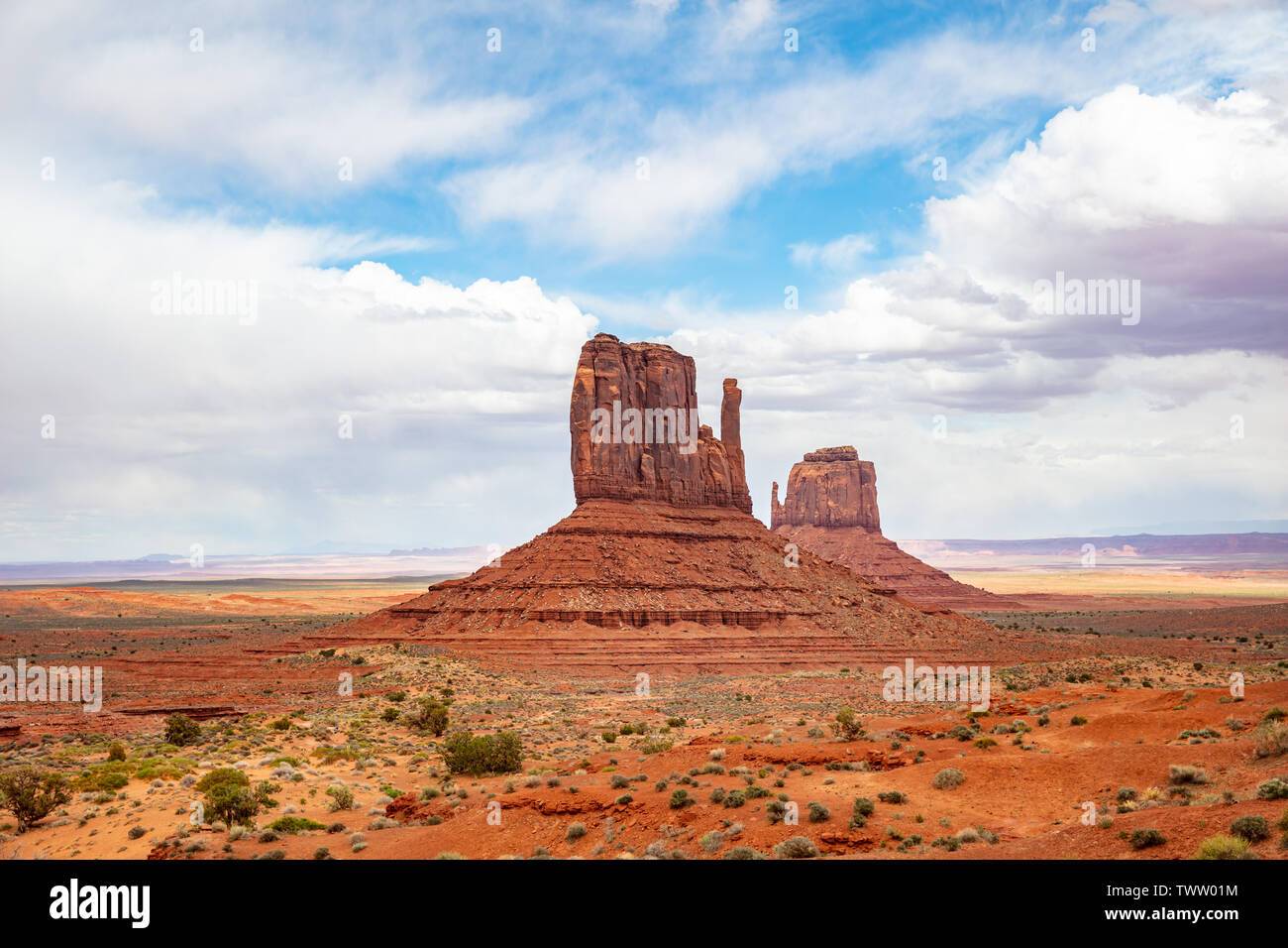Monument Valley, Navajo Tribal Park in the Arizona-Utah border, United States of America. Red rocks against cloudy sky background Stock Photo