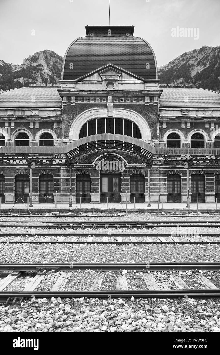 Entrance front view of the abandoned Canfranc International railway station and its railway tracks (Canfranc, Pyrenees, Huesca, Aragon, Spain) Stock Photo